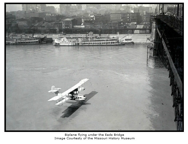 Biplane Flying Under Eads Bridge